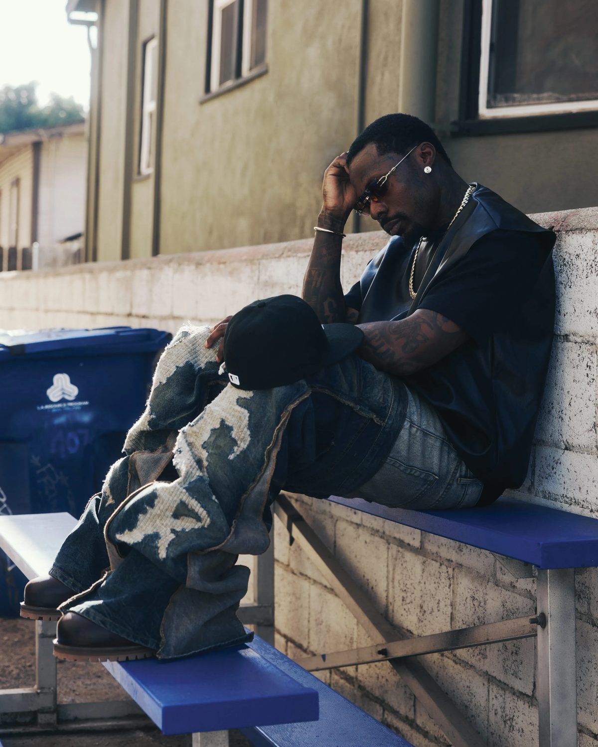Airbnb: Asake outside a residential building for FLAUNT, Issue 203