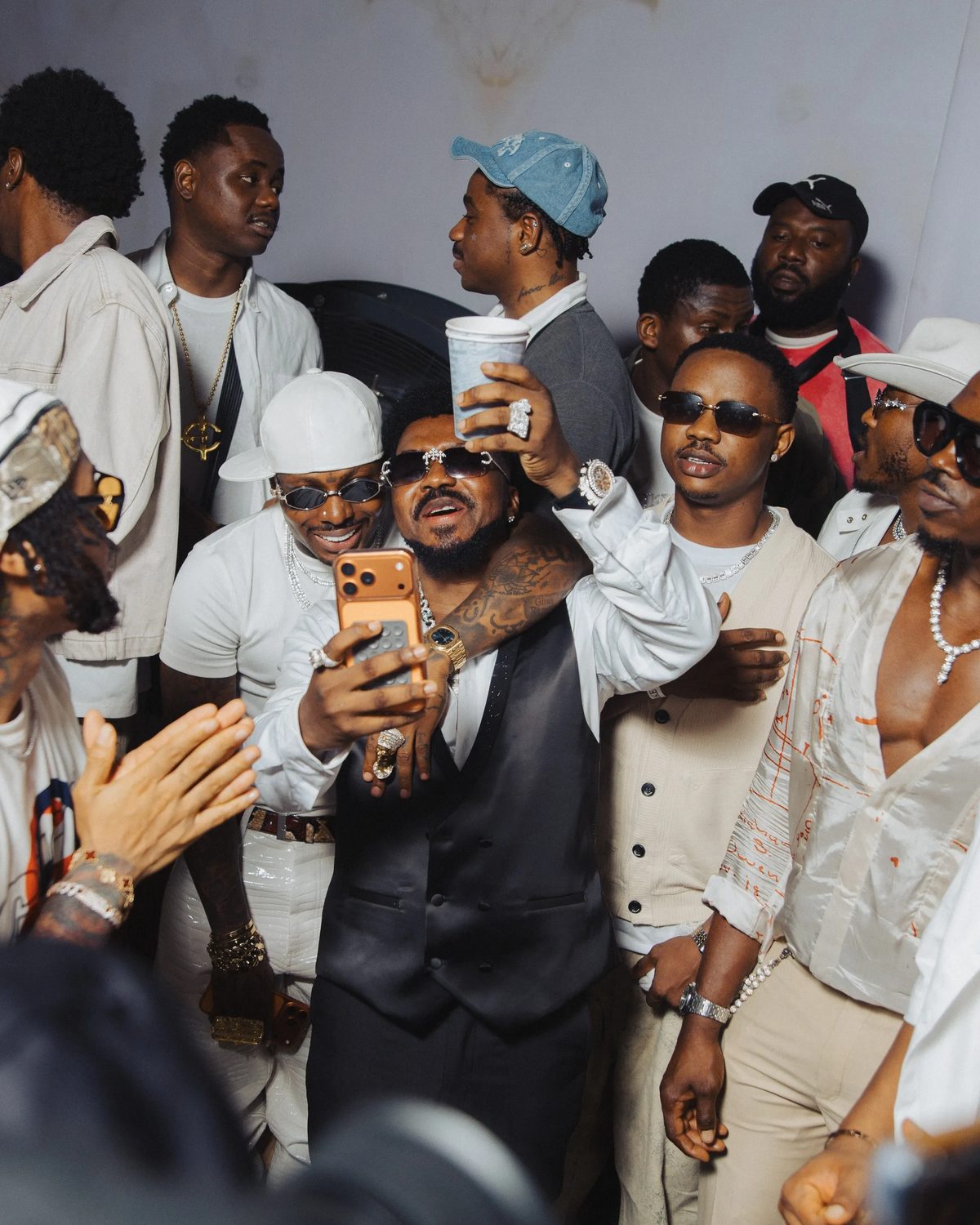 Tecno: Asake posing for a phone photo at the M$NEY launch, Lagos · April 30, 2026